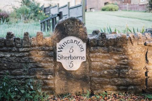 Old signpost set into wall opposite the church.