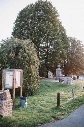 Chain Fencing edges the village green.  On the green is the village notice board, the original water pump and model plan of the village from 1994.