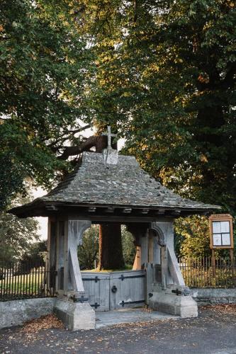 Lychgate at St Peter & St Paul church in village.